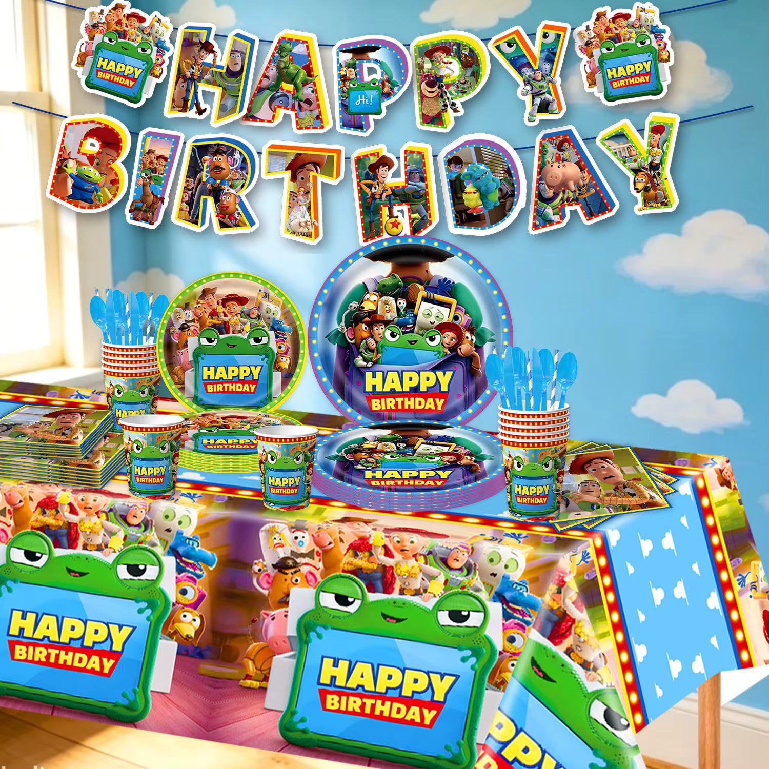 Vue d'ensemble du kit d'anniversaire comprenant une nappe décorée, des assiettes, des gobelets, des couverts et une banderole Happy Birthday thème jouets.