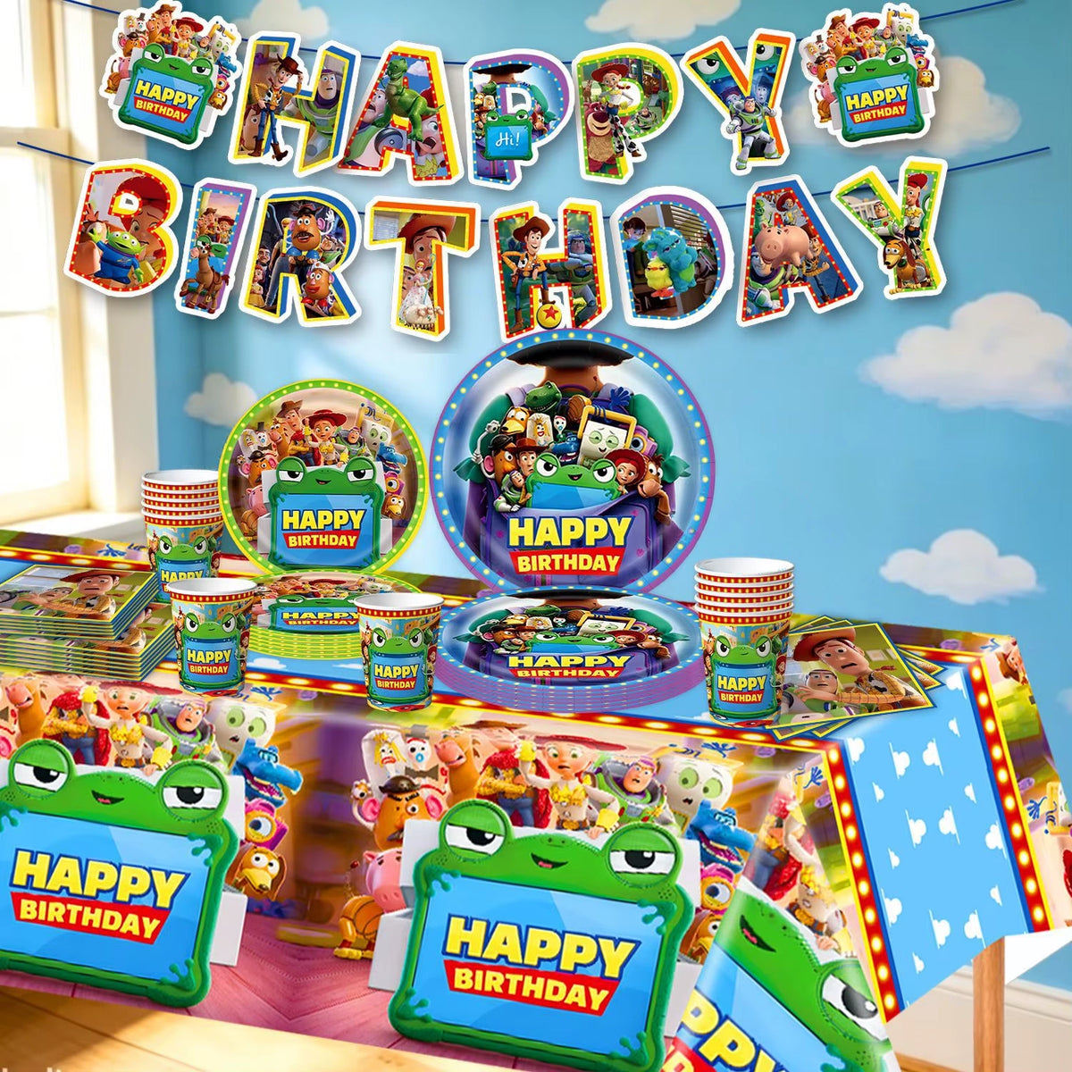 Vue d'ensemble du kit d'anniversaire comprenant une nappe décorée, des assiettes, des gobelets, des couverts et une banderole Happy Birthday thème jouets.